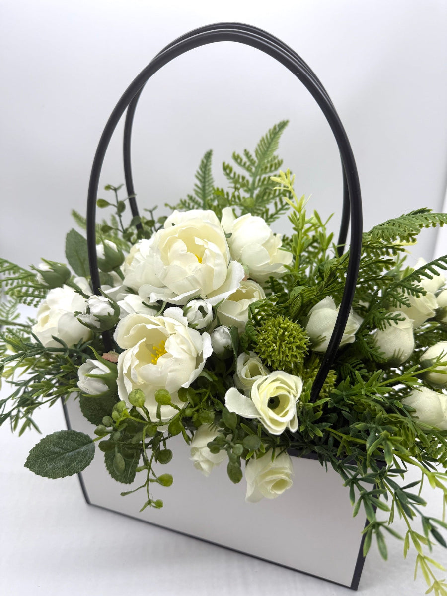 white rosues with vivid greenery bouquet in white gift bag