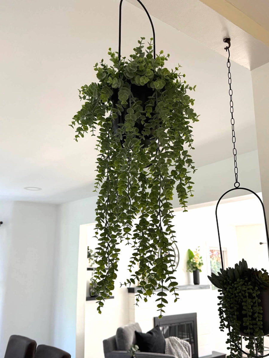 hanging faux eucalyptus plant with cascading stems in modern metal black matte planter