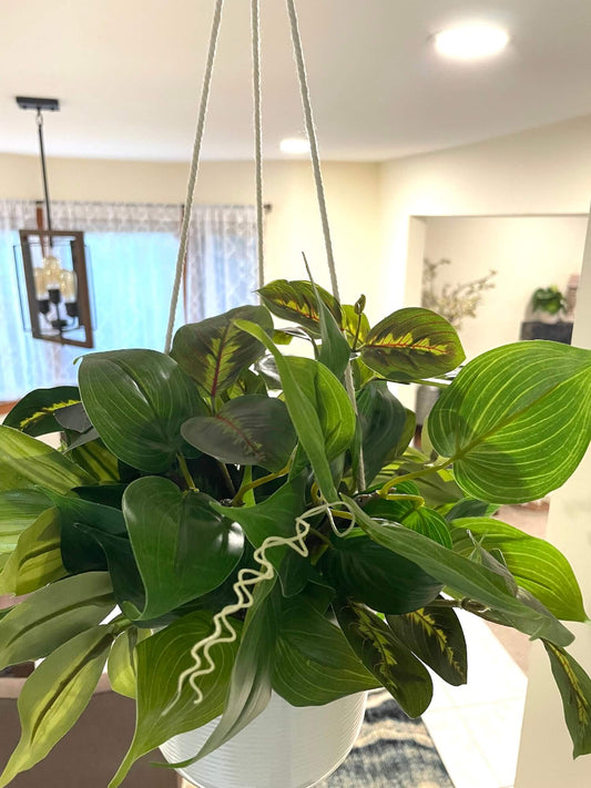 mix of faux plants of variety of green shades and shape in white ceramic hanging pot