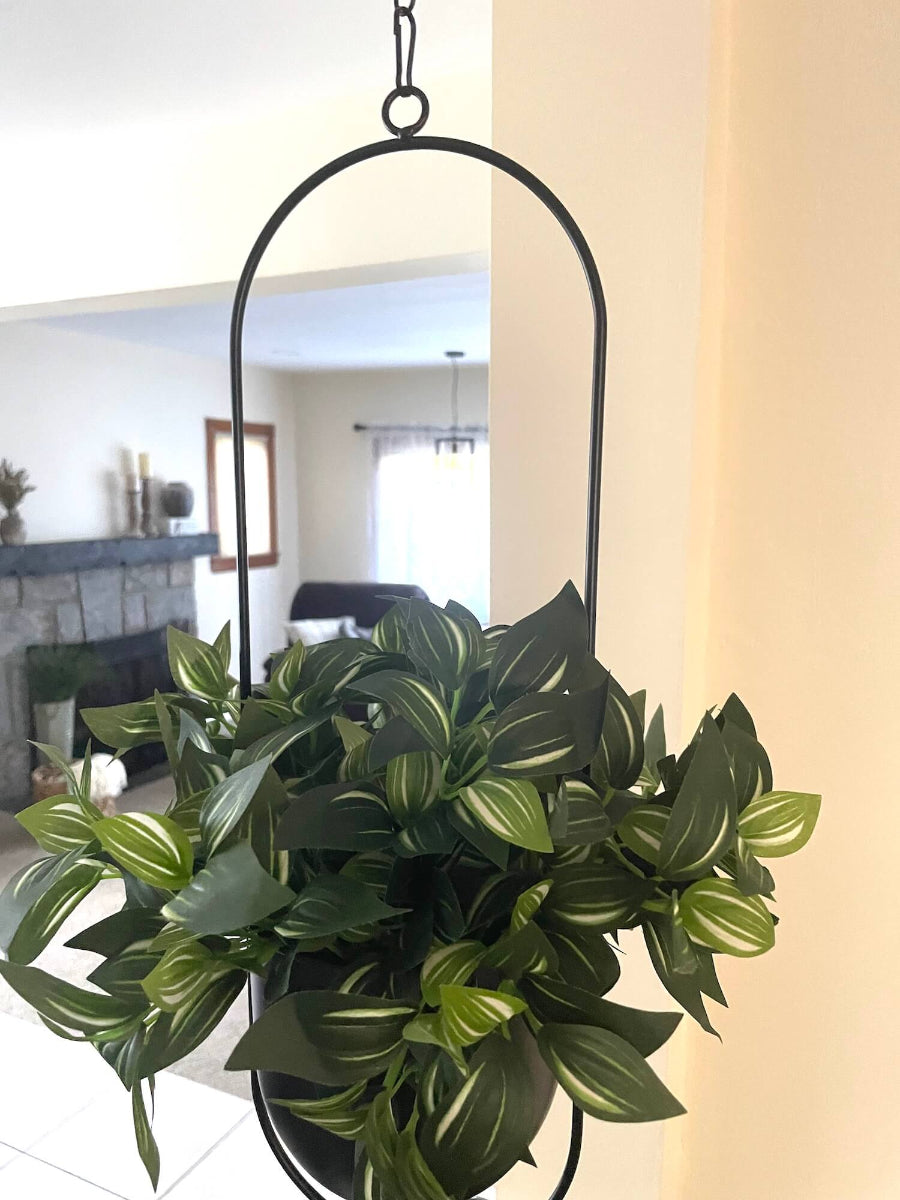 faux plant with green leaves and white stripes in balcer metal planter on chain
