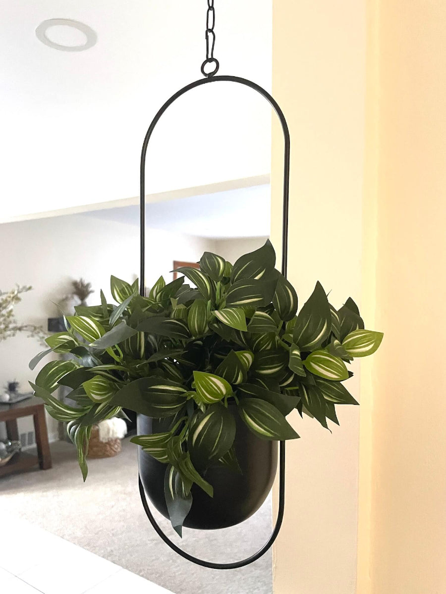 faux plant with green leaves and white stripes in balcer metal planter on chain