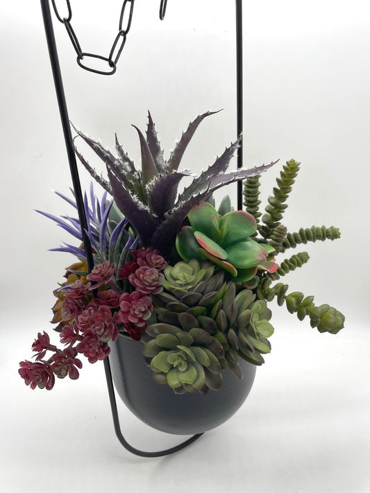 Hanging Faux Succulents-variety of realistic succulents in different shape and size from different shades of green to burgundy and purple in oval ganging metal planter on a chain
