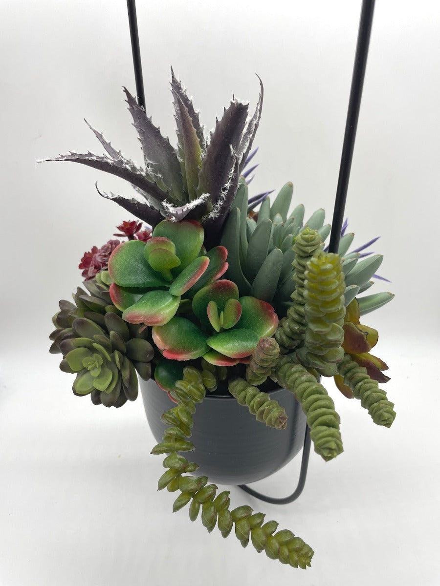 Hanging Faux Succulents-variety of realistic succulents in different shape and size from different shades of green to burgundy and purple in oval ganging metal planter on a chain