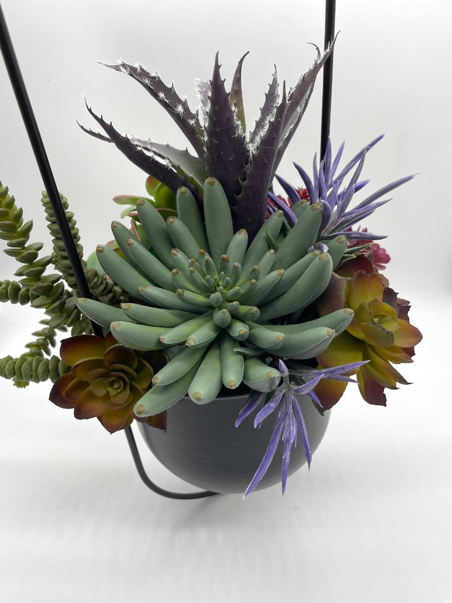 view from top of Hanging Faux Succulents-variety of realistic succulents in different shape and size from different shades of green to burgundy and purple in oval ganging metal planter on a chain