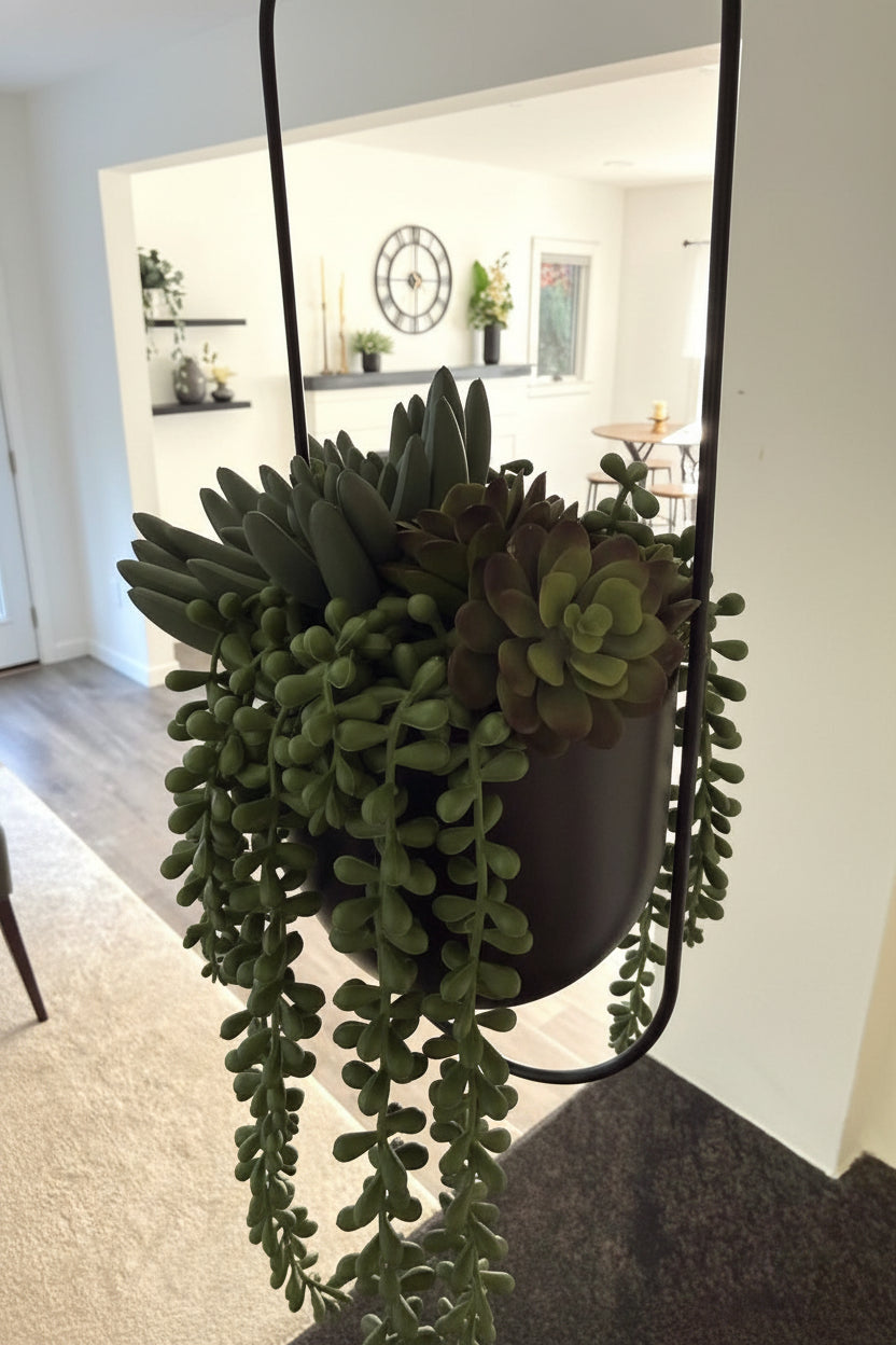 realistic looking succulents arrangement in hanging black metal planter on a chain