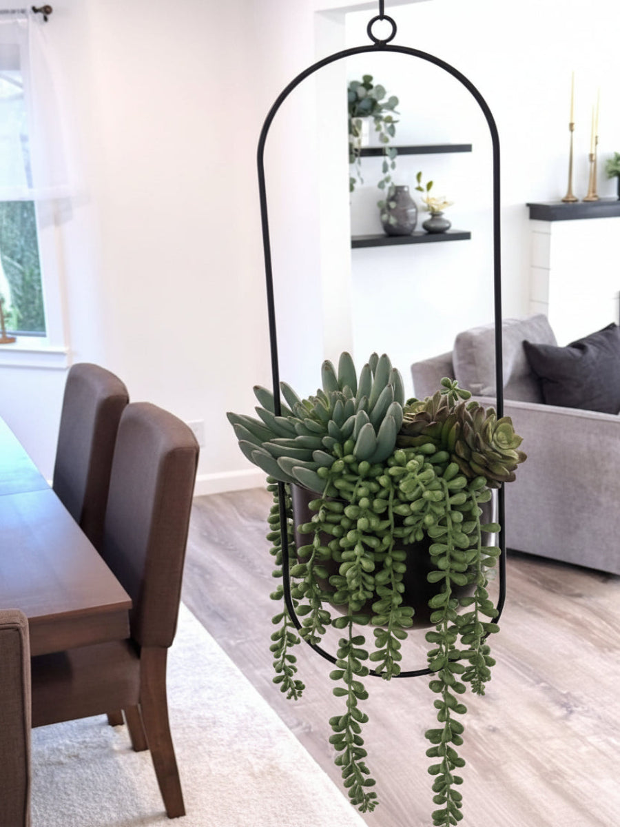 realistic looking succulents arrangement in hanging black metal planter on a chain
