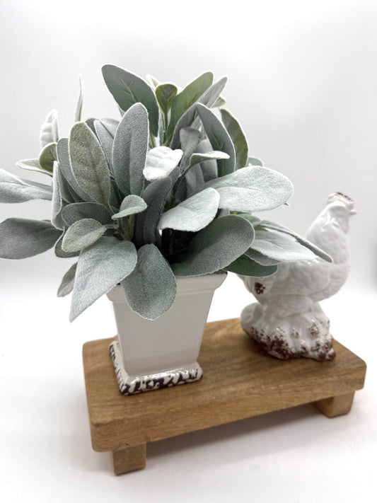 realistic faux lambs ear arrangement in white square ceramic vase