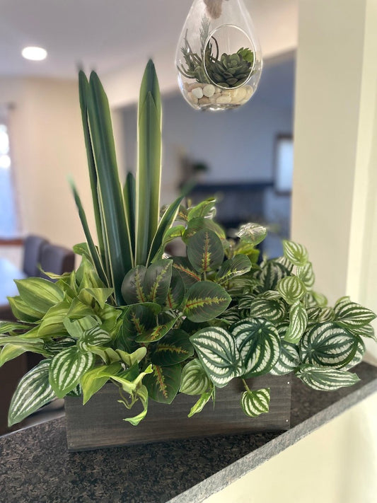 mix of few faux plants in  Wooden Planter stained in expresso color creating tall an large arrangement