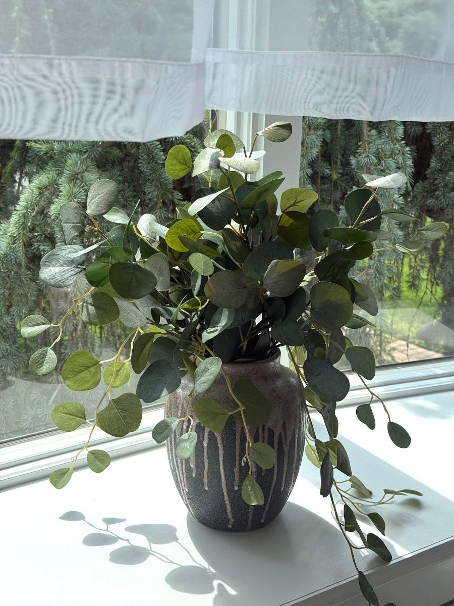 Large realistic looking Faux Silver Dollar Eucalyptus in unique Ceramic Vase styled in bay window