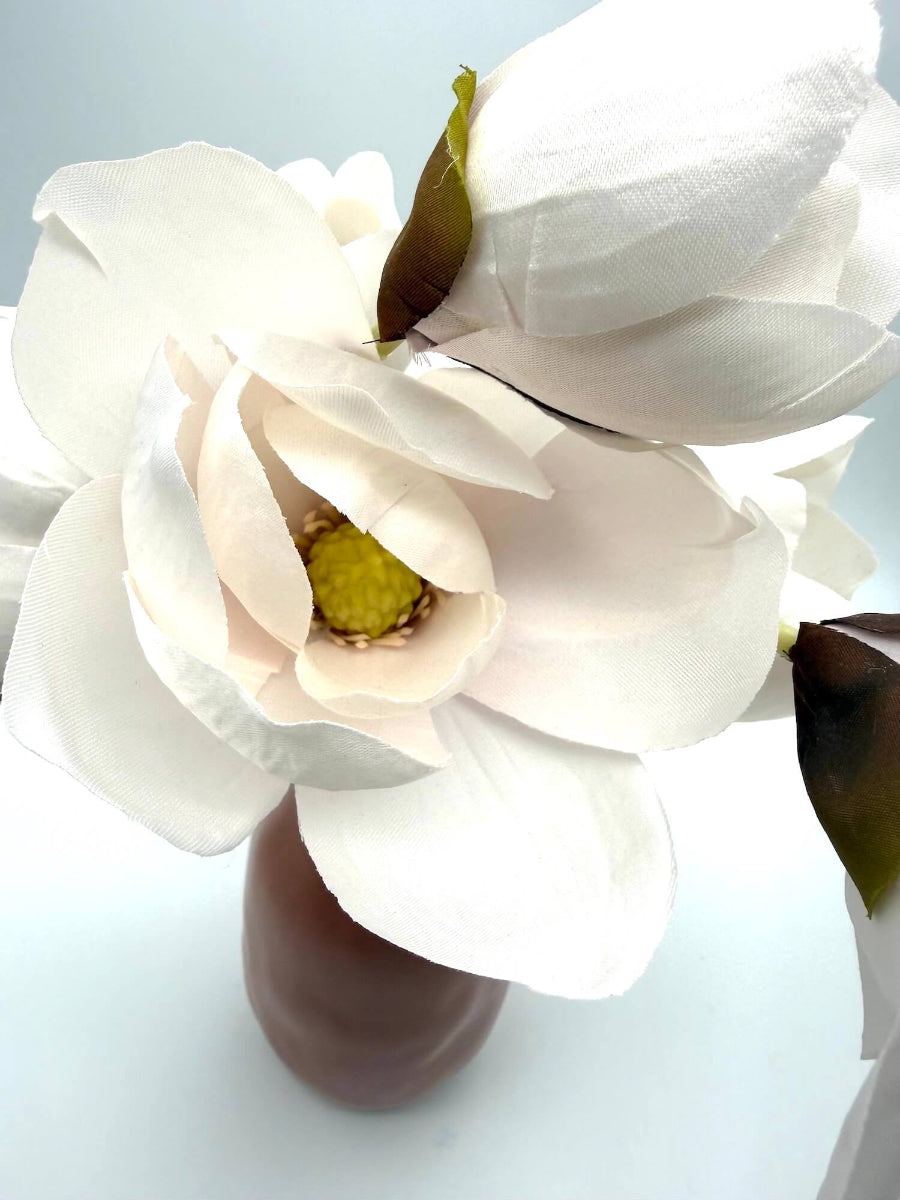 white-ish magnolia flower in arrangement in vase