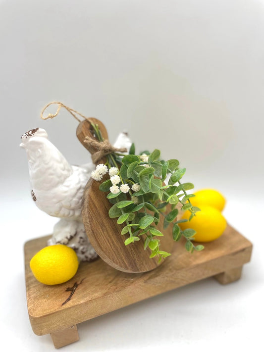 Mini Cutting round wooden Board Decorated with eucalyptus stems and white flowers and finished with jute
