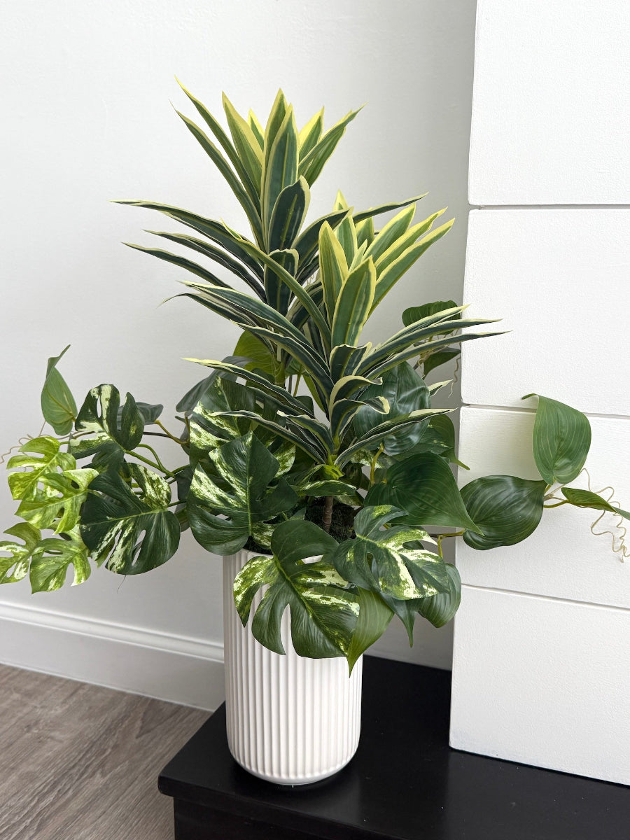 tall arrangement, mix of 3 realistic looking vivid green faux plants with leaves in green and green-white, placed in tall white ceramic textured pot vase
