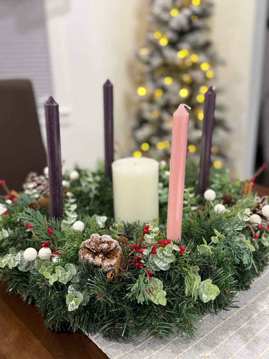 handmade lush elegant evergreen advent wreath with arborvitae and snowy eucalyptus stems decorated with pinecones, red and white berries and cinnamon stick, with four taper candles in purple/pink, red or white perfect for dining table
