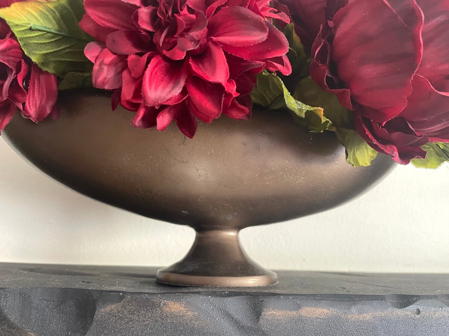 Bronze vase with red flowers elegant centerpiece