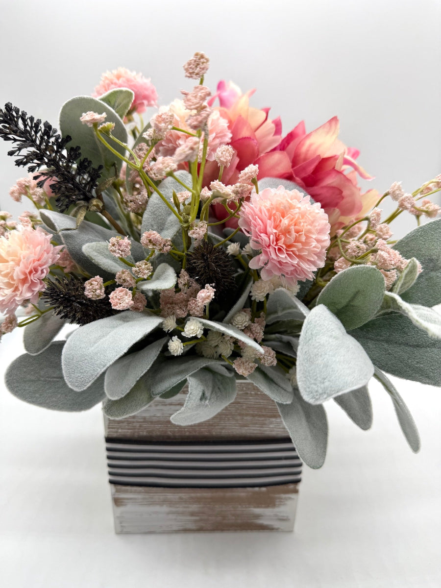 floral arrangement with variety of pink, white and black stems and lambs ear
