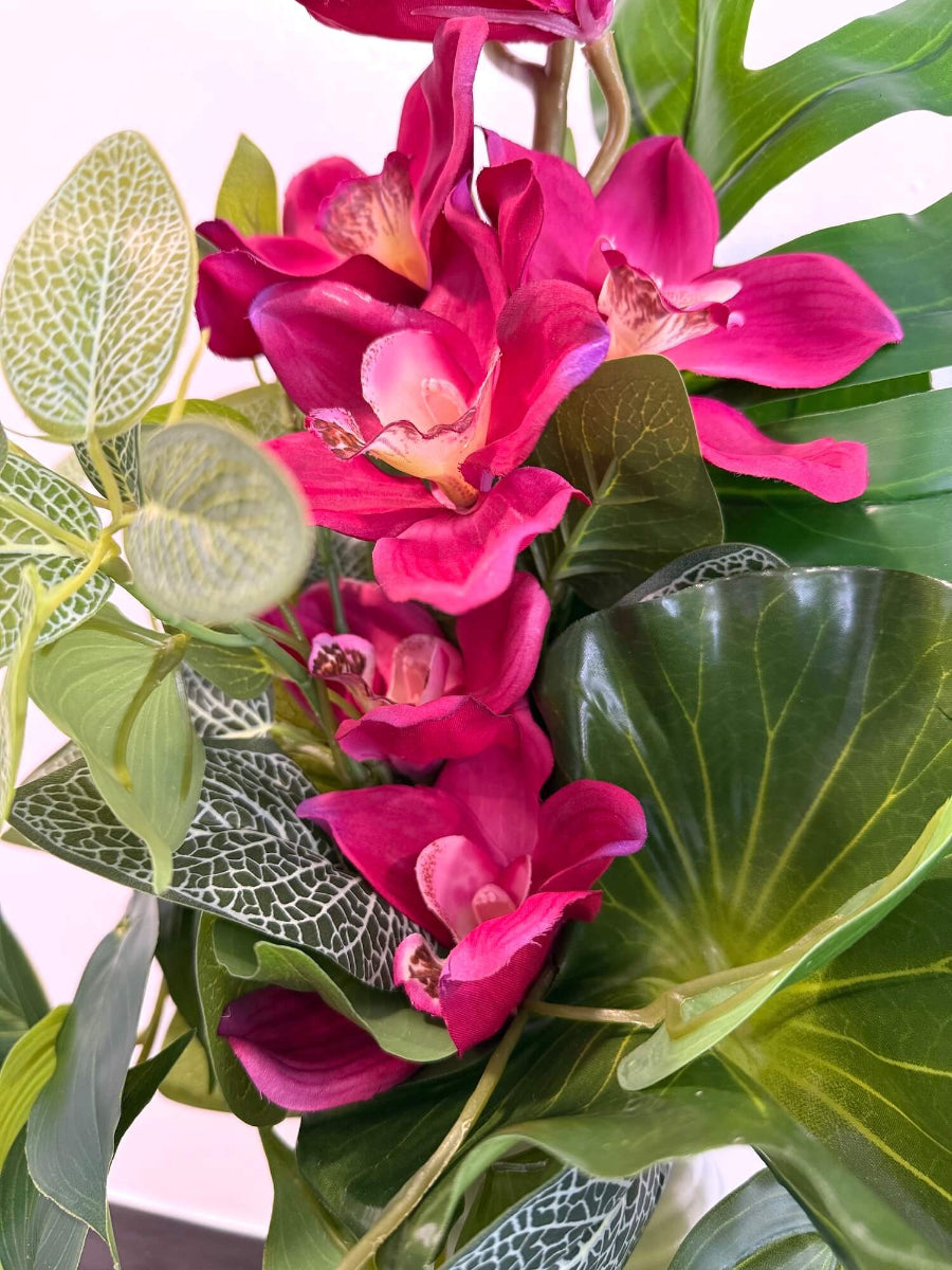 vivid pink orchid and greenery close up