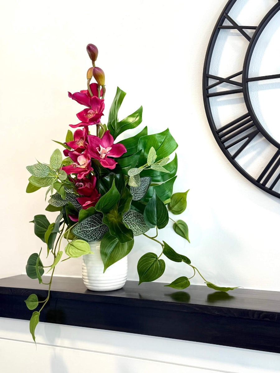 realistic elegant vivid orchid arrangement and greenery in white ceramic vase