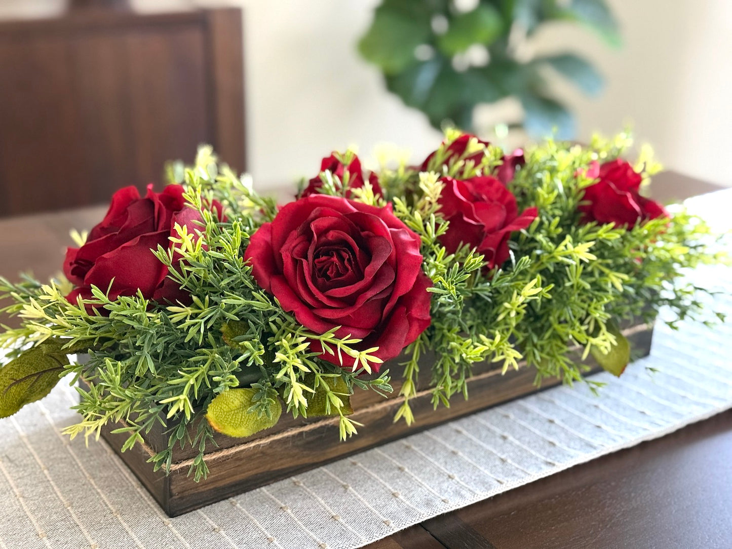 beautifyl red roses with greenery in wooden planter vase