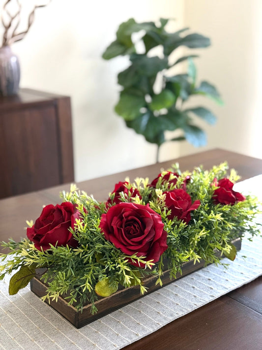 deep red roses with greenery in wooden long planter