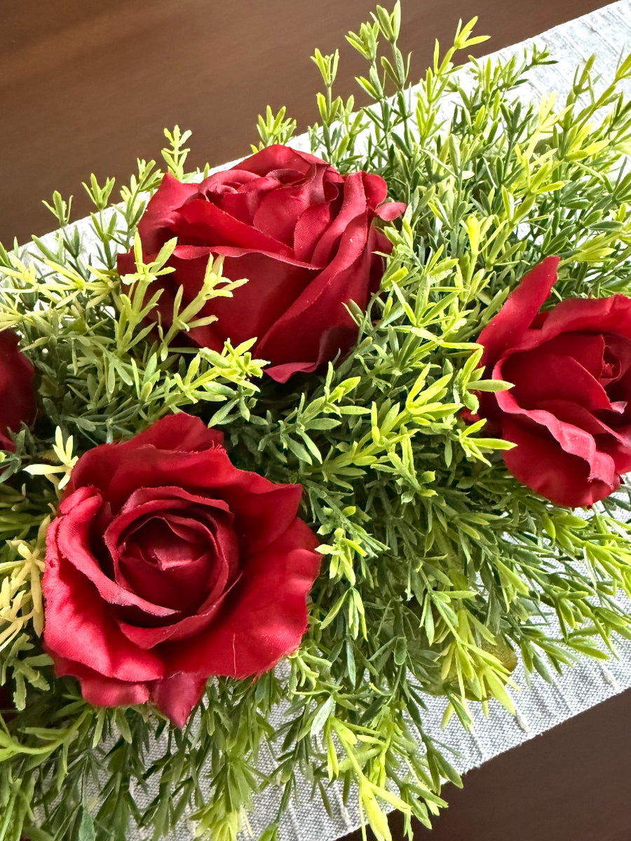 realistic red and vivid greenery roses in wooden vase