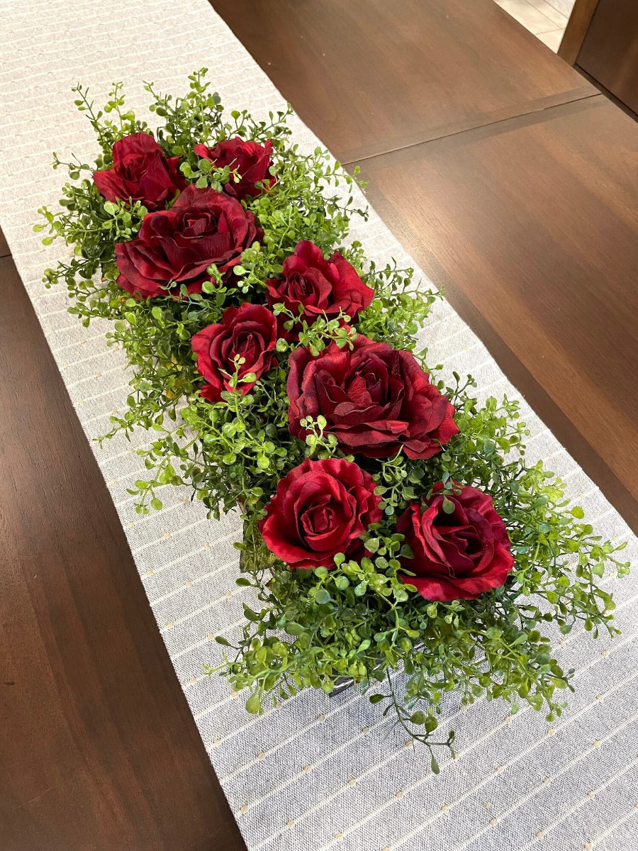 view from top of realistic deep red roses and vivid greenery in  wooden planter stained is expresso color