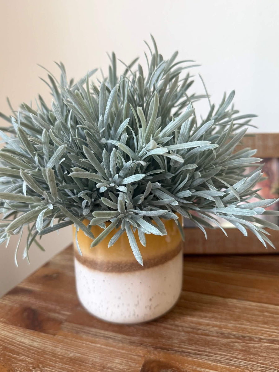 realistic looking lush faux rosemary plant in yellow ceramic pot