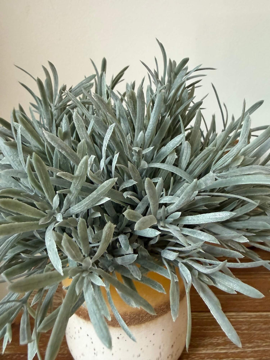 close up for realistic looking lush faux rosemary plant in yellow ceramic pot