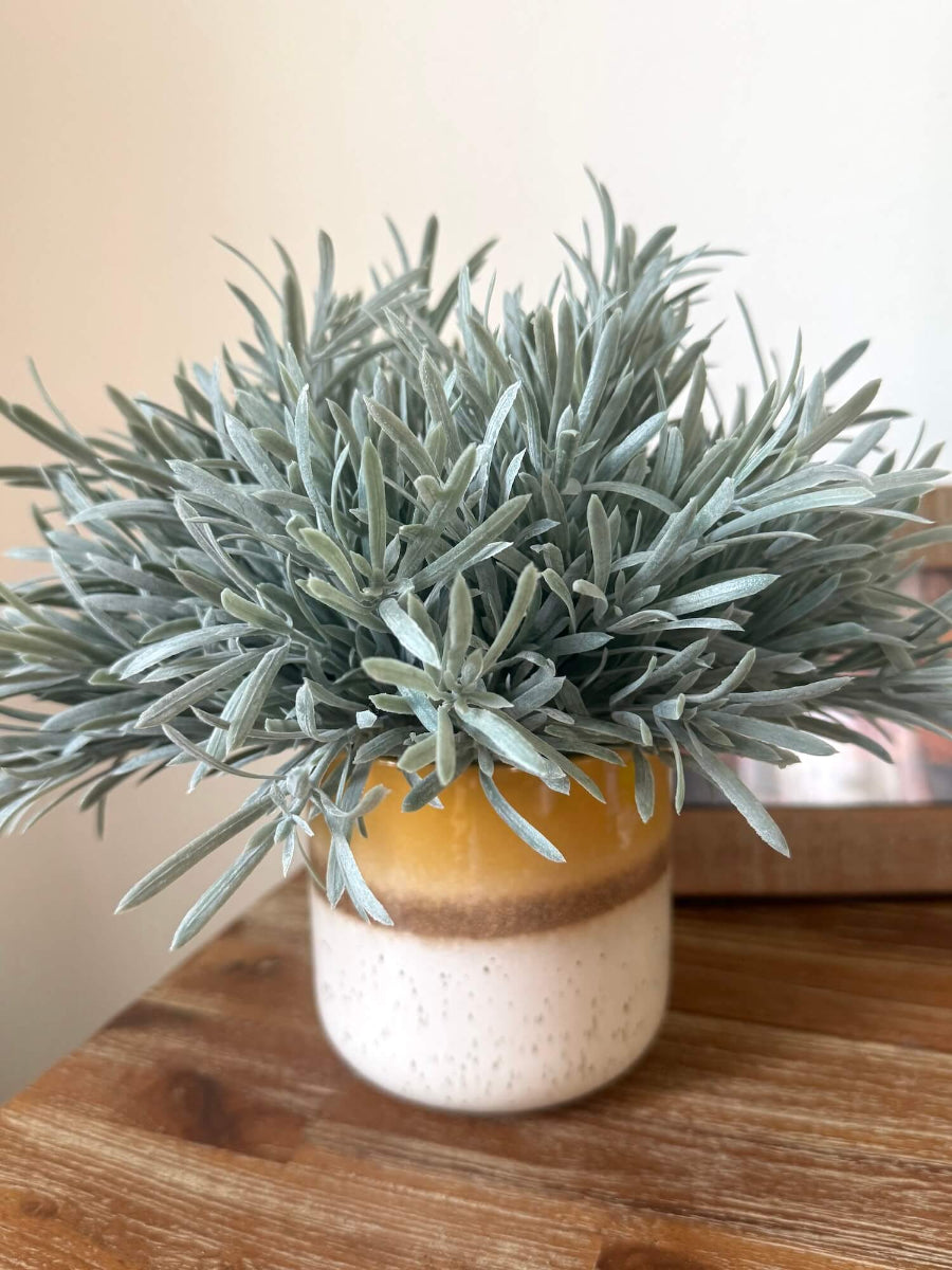 realistic looking lush faux rosemary plant in yellow ceramic pot