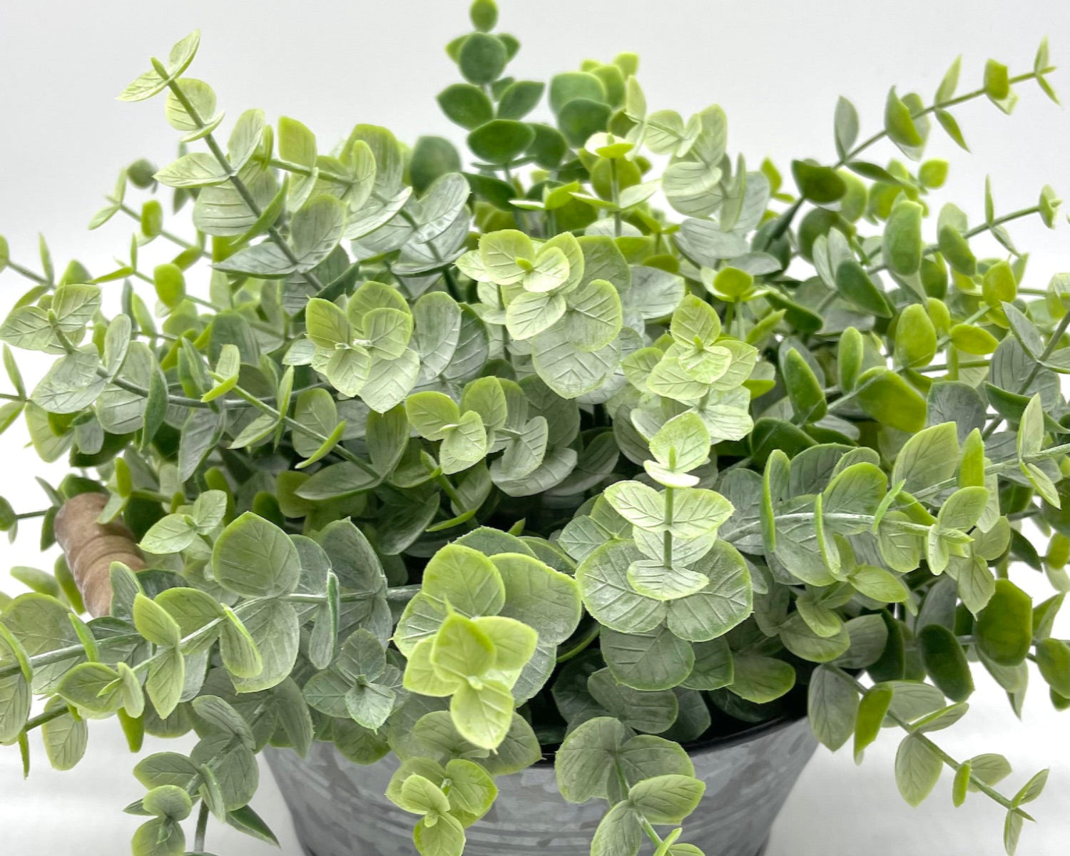 view from top and close up for realistic faux eucalyptus arrangement in round metal galvanized planter with handles in modern farmhouse style