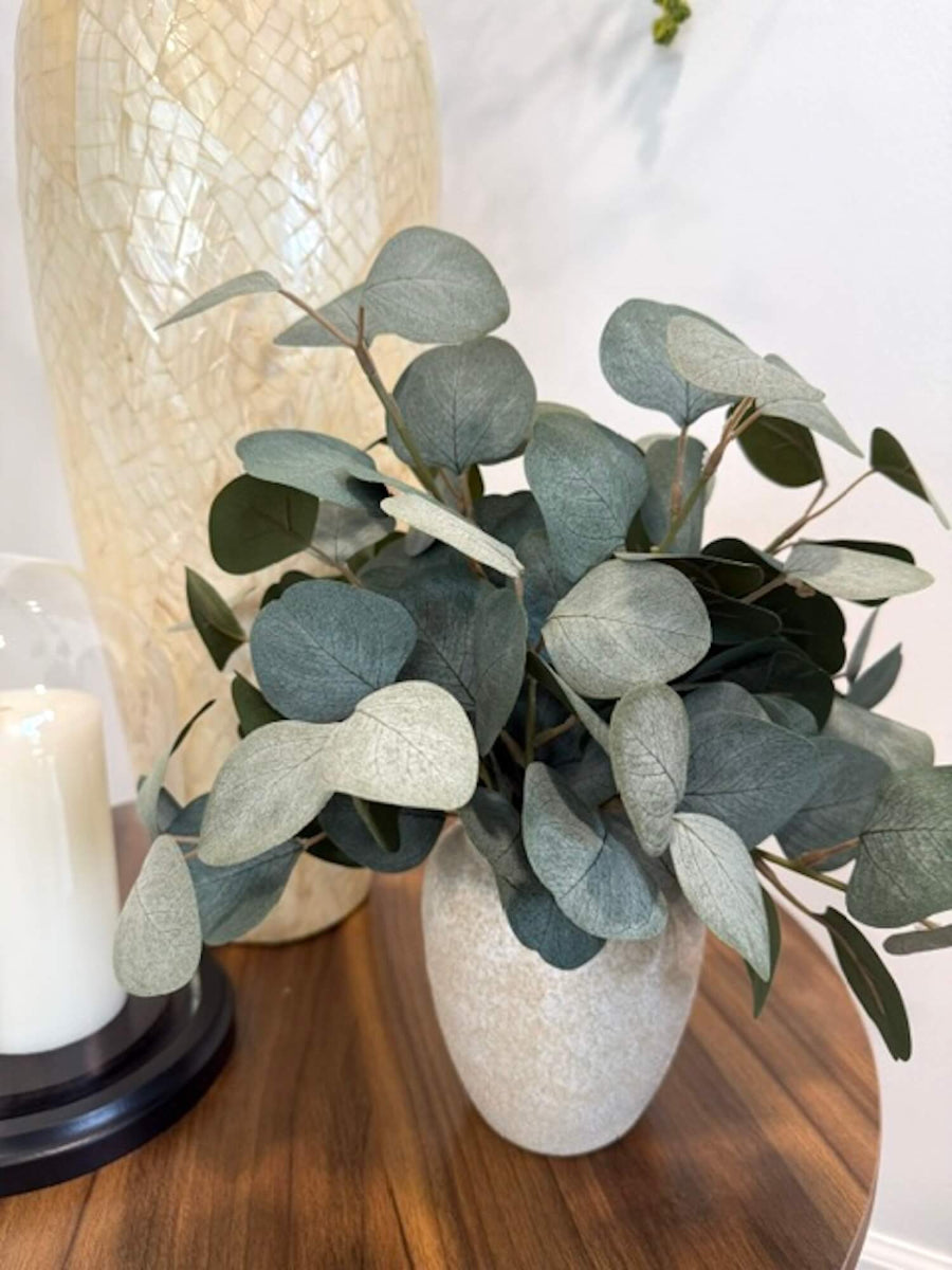elegant realistic lush silver dollar eucalyptus in stone-like ceramic beige vase