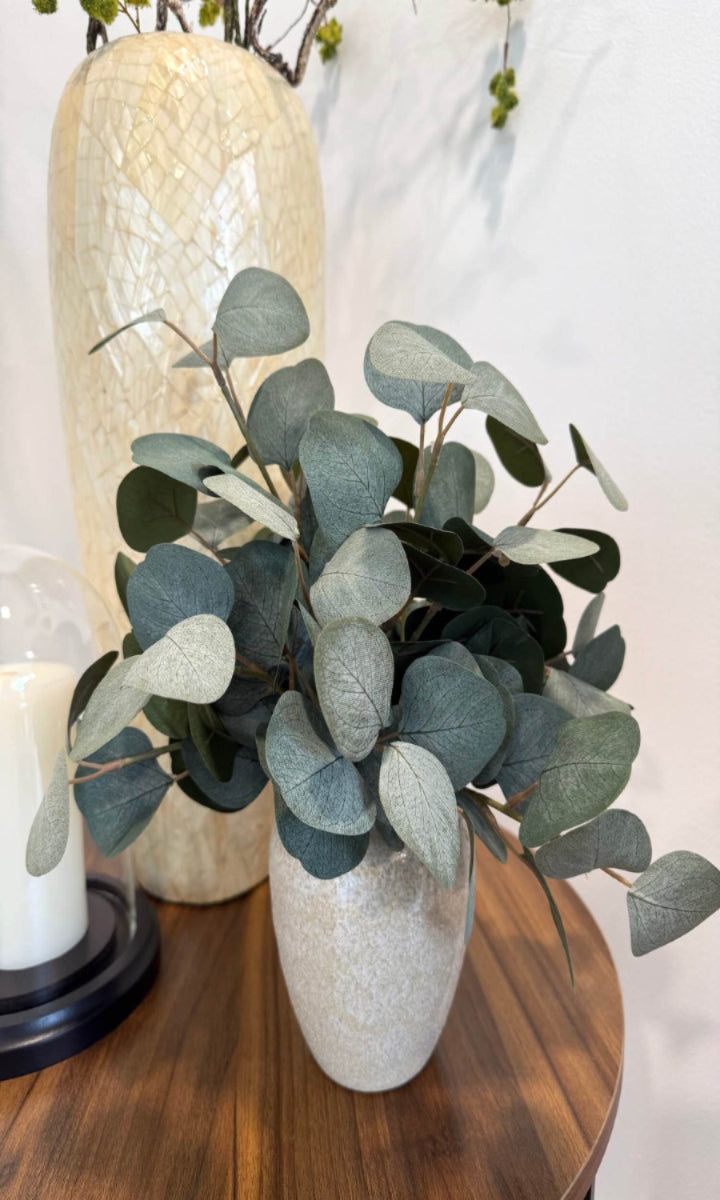 elegant realistic lush silver dollar eucalyptus in stone-like ceramic beige vase