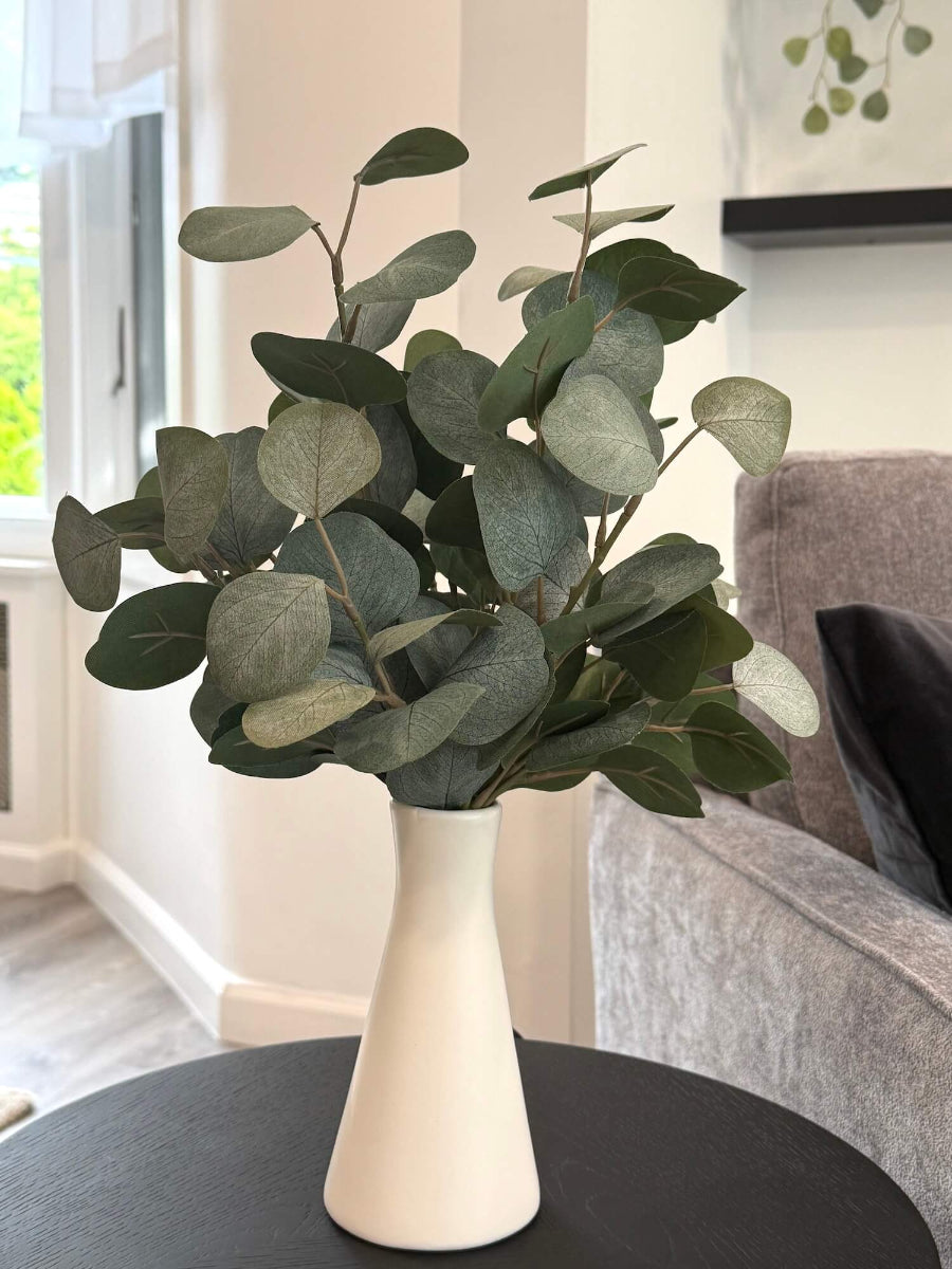 elegant faux silver dollar eucalyptus in white ceramic vase
