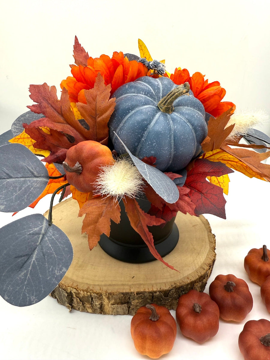 Small Fall Centerpiece in Black Ceramic Vase with fall flowers, leaves, wheat stems and pumpkin in orange and blue