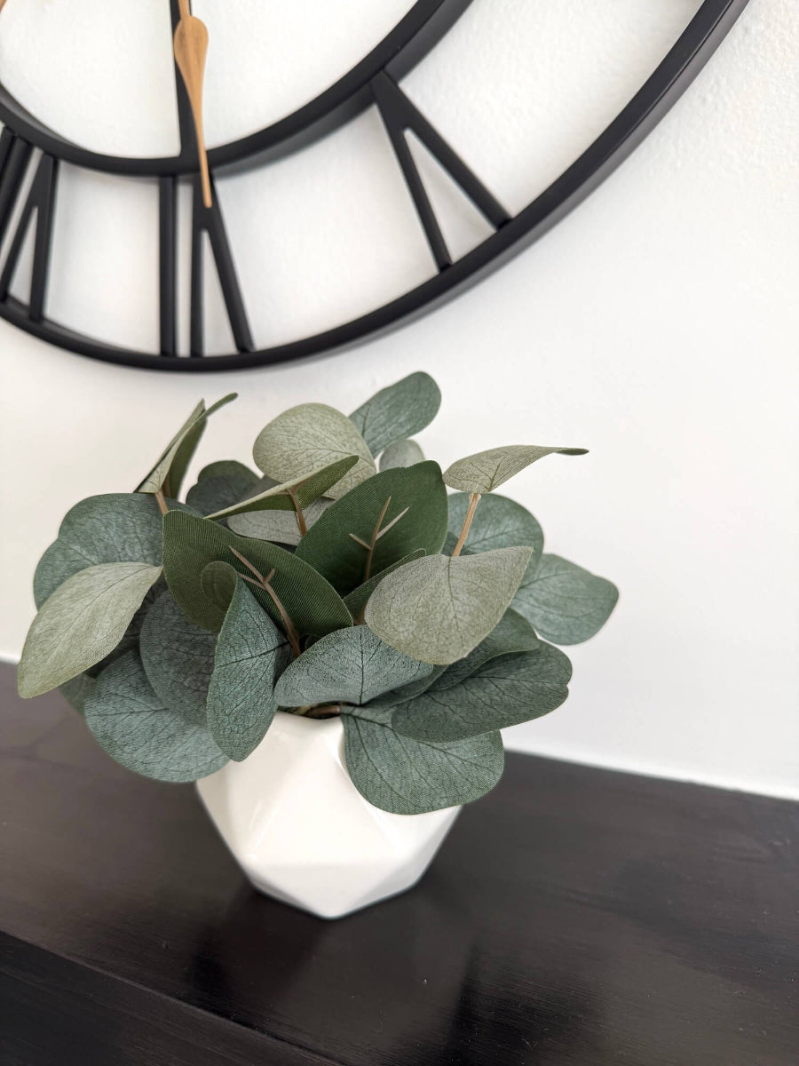 small lush realistic silver dollar eucalyptus in white ceramic white vase
