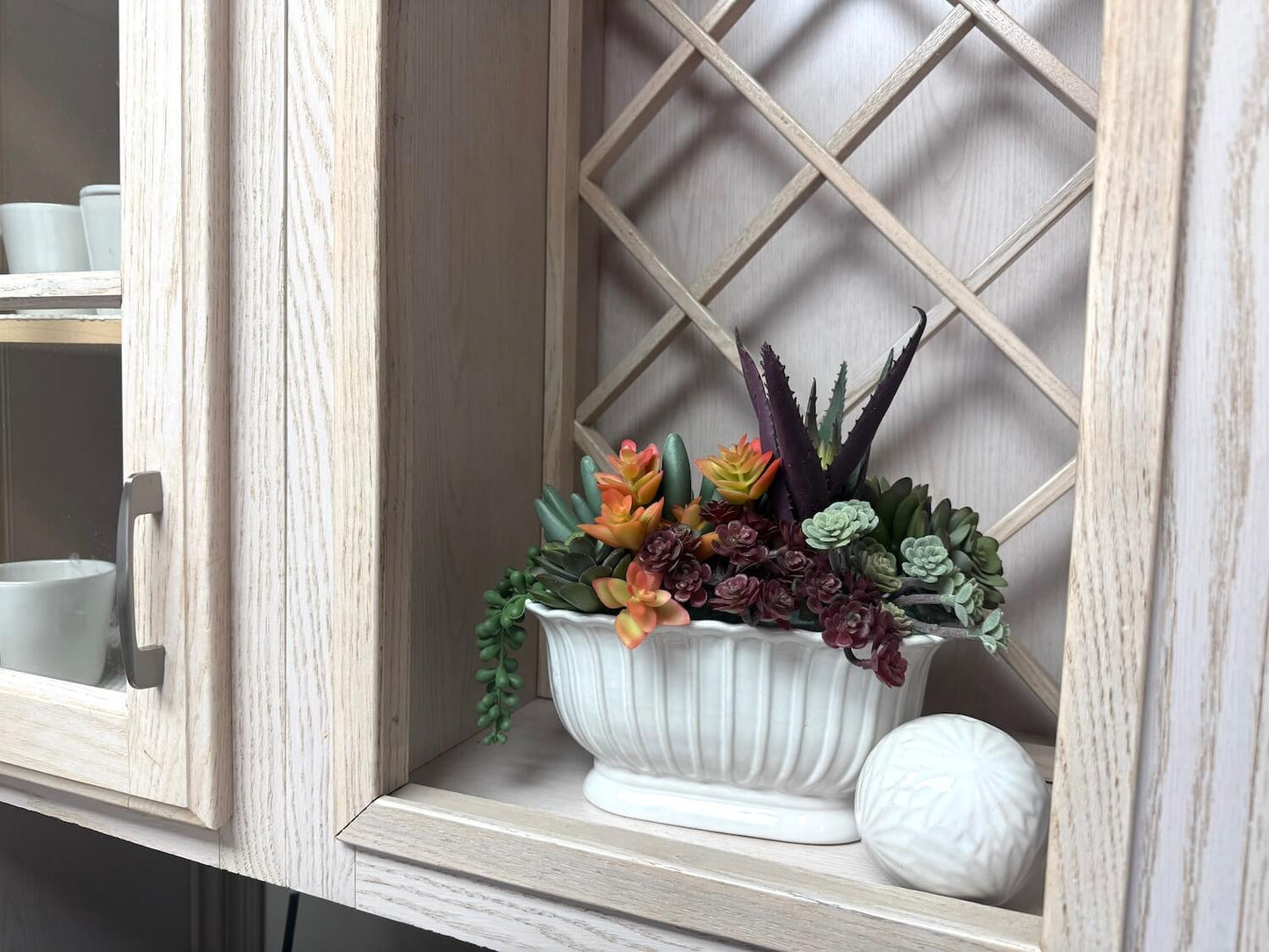 realistic looking faux succulent arrangement in long ceramic textured vase for kitchen decor