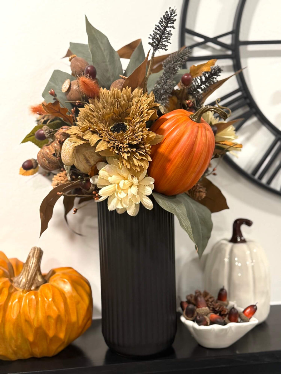 elegant lush realistic tall fall arrangement with flowers, leaves, pumpkins, autumn berries in black ceramic vase