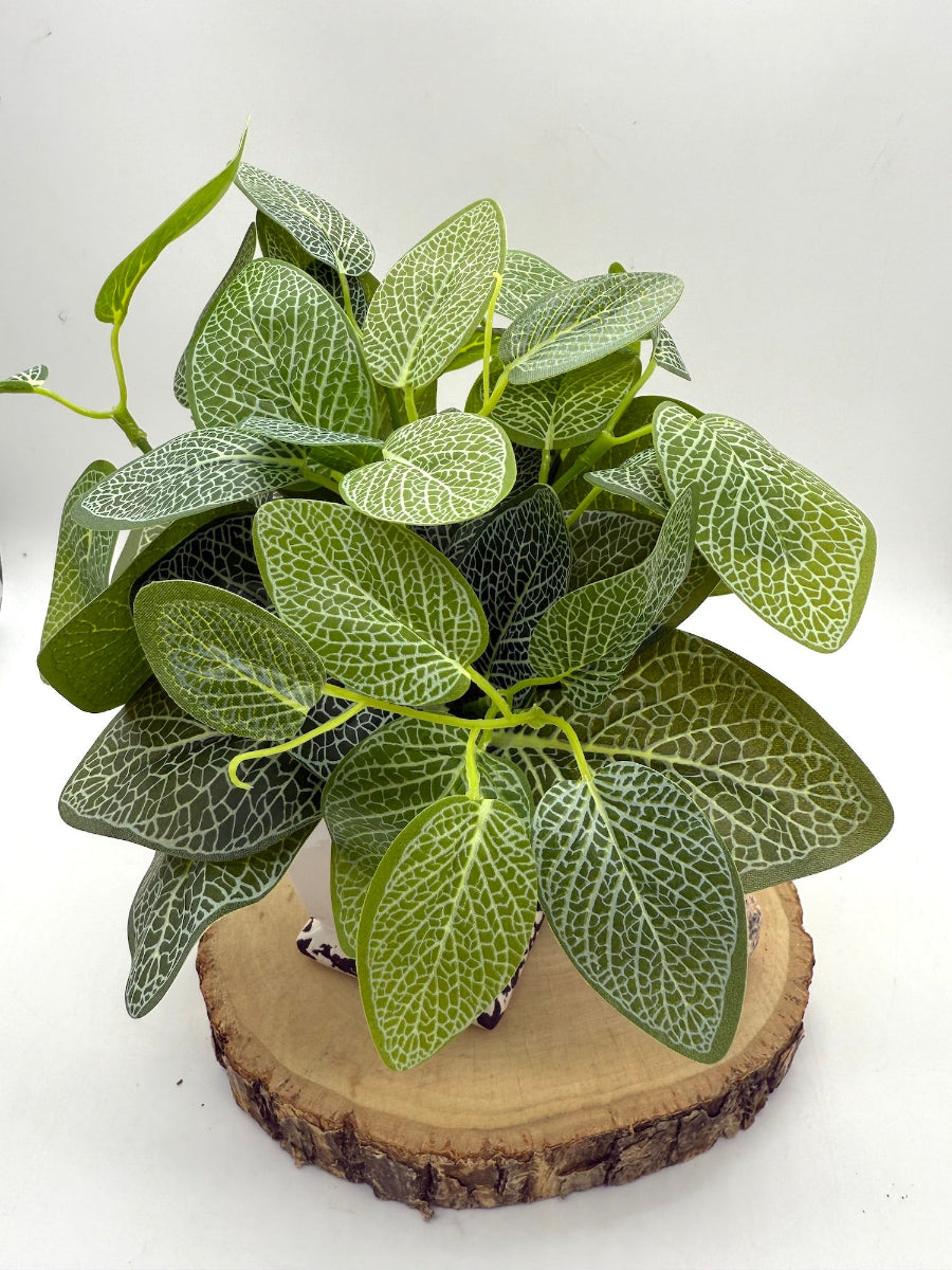 view from top of faux plant with big leaves in vivid green color and white veins