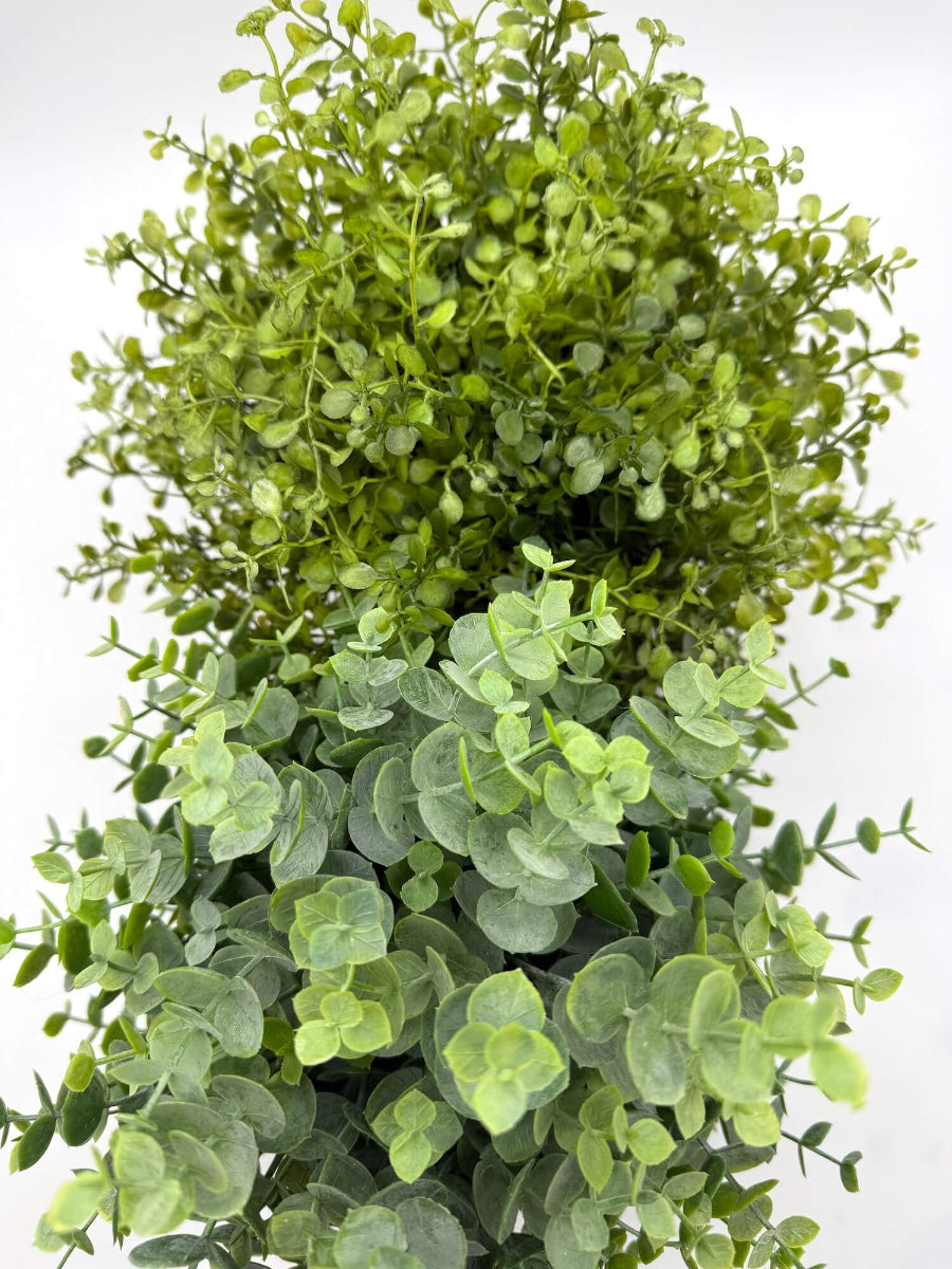 view from top on two faux plants - faux eucalyptus and vivid greenery