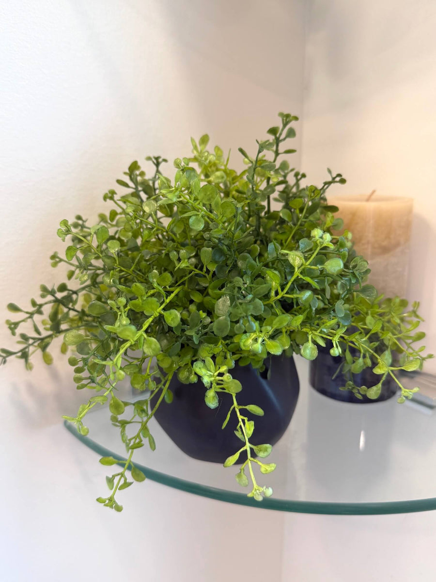 small realistic looking vivid faux greenery in geometric black matte pot vase