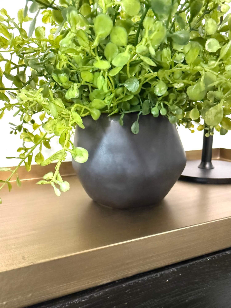 close up for vase of small realistic looking vivid faux greenery in geometric black matte pot vase