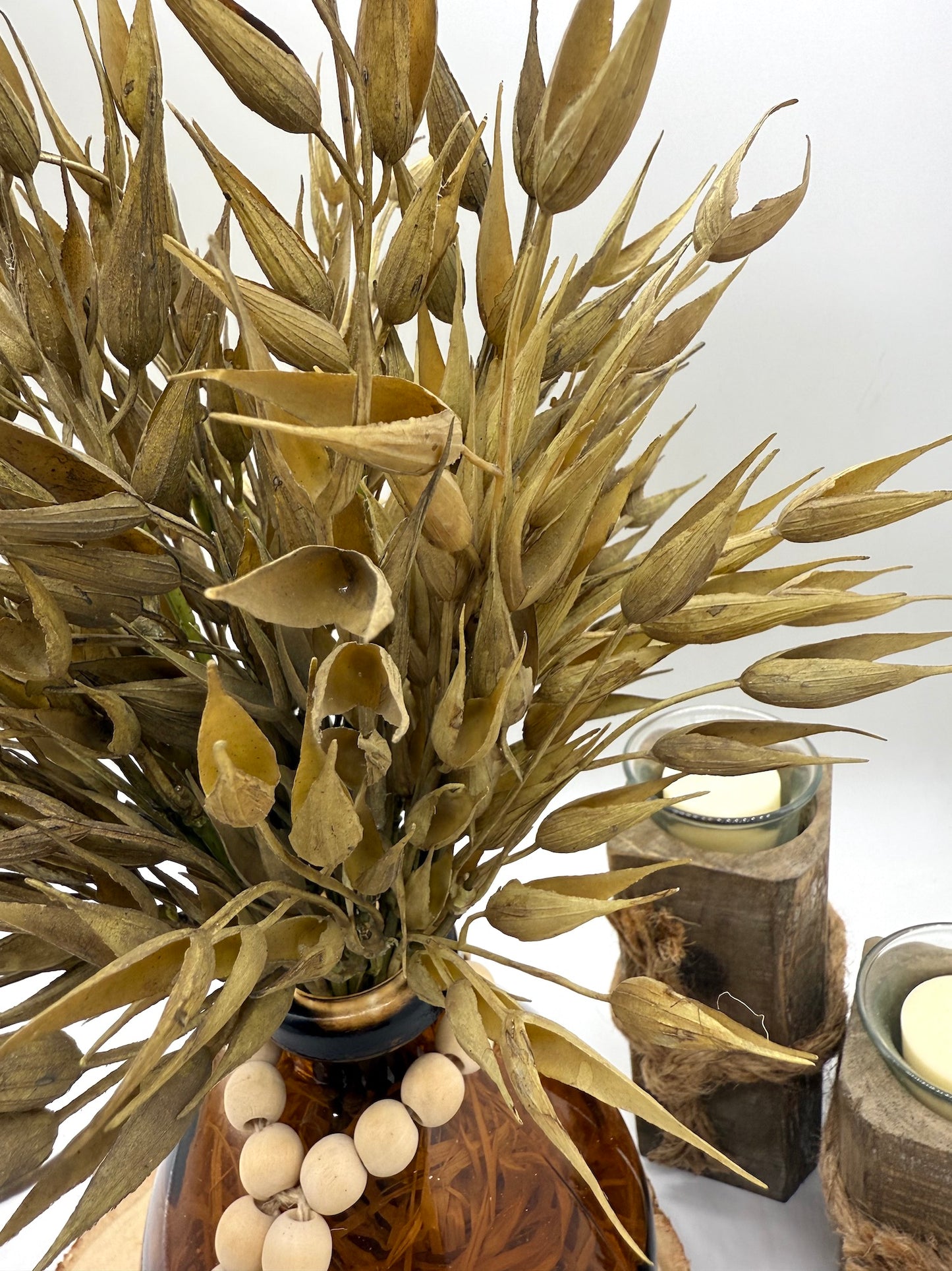 Faux Wheat Bouquet in Round Brown Bottle Vase