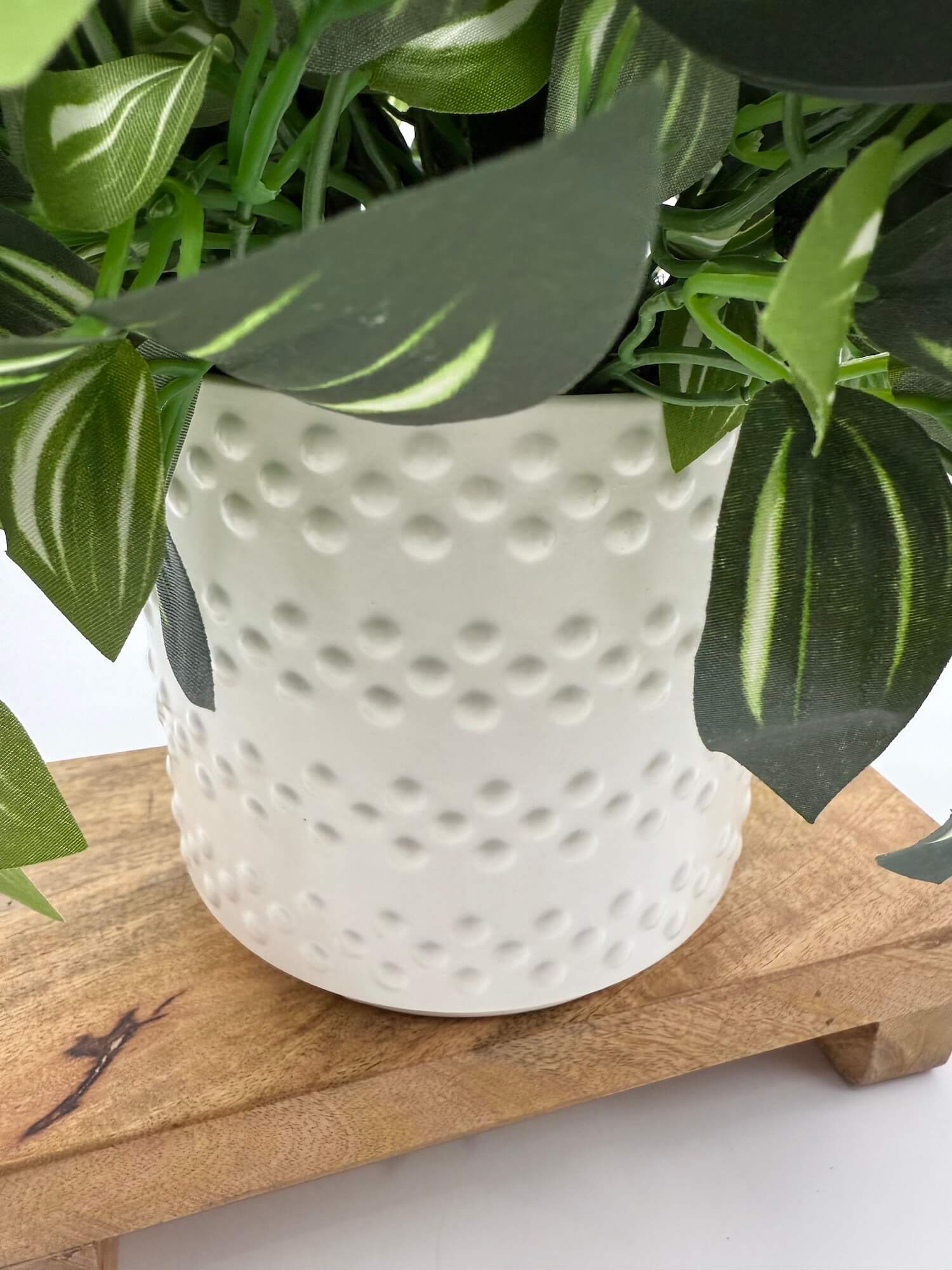 elegant white ceramic vase with vivid green silk greenery