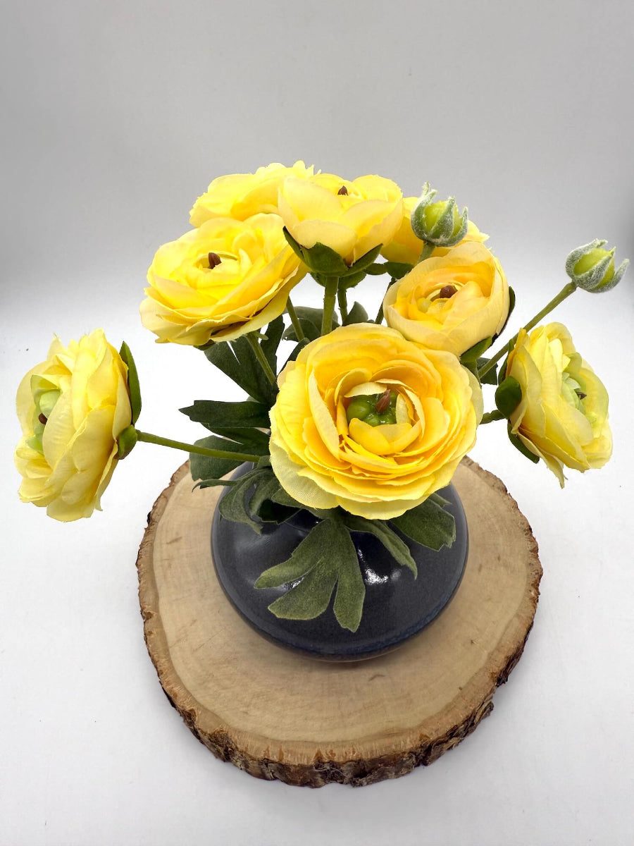 realistic yellow rancunculus flower bouquet in gray ceramic vase