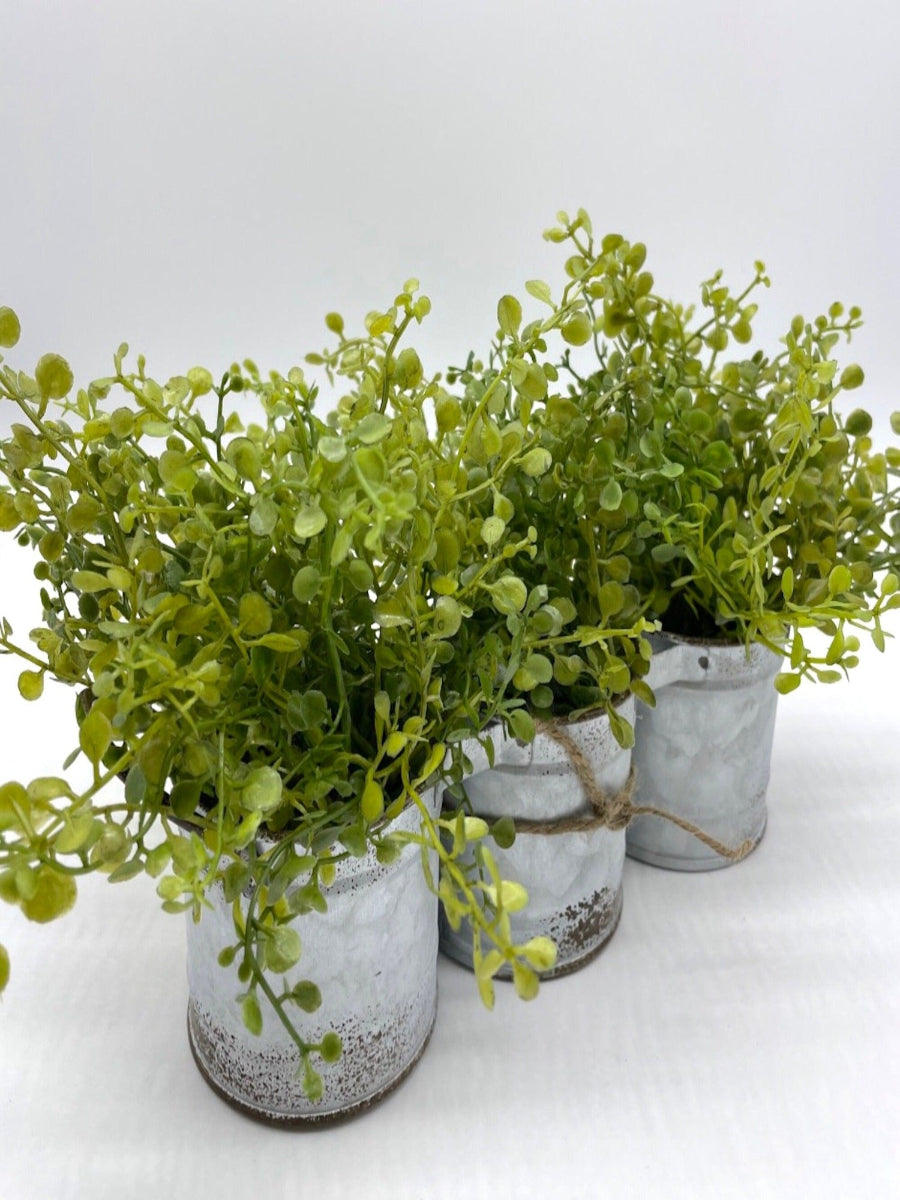 vivid green faux greenery in triple can metal galvanized planter with handles decorated with jute, in modern farmhouse style