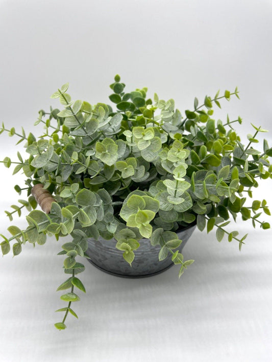 realistic faux eucalyptus arrangement in round metal galvanized planter with handles in modern farmhouse style