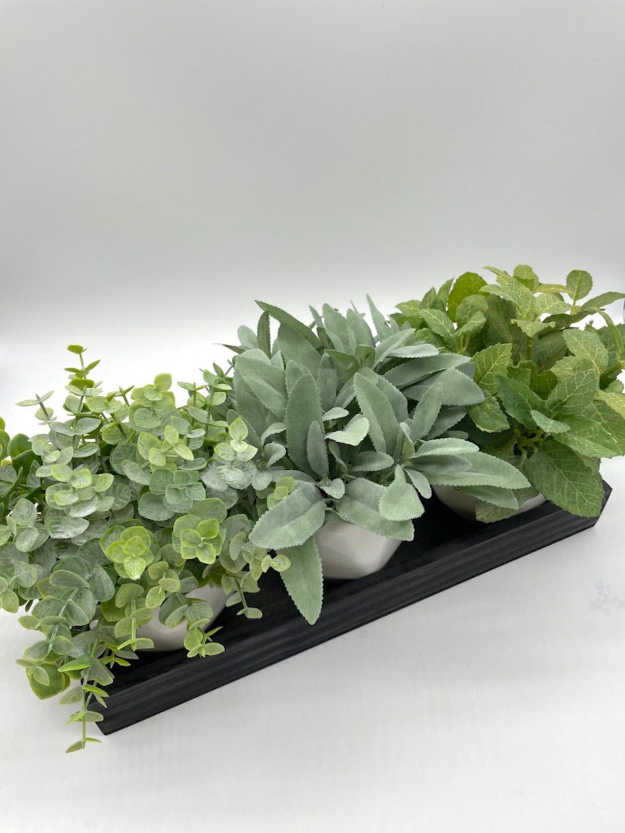 view from top on realistic Herb Themed Arrangement SET of 3 faux herbs: eucalyptus, mint, sage in white ceramic vases set on a black wooden tray