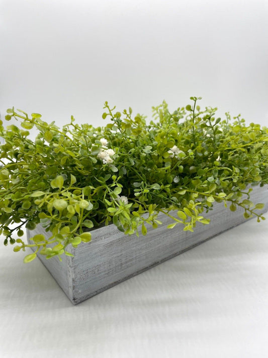 realistic looking vivid green faux Greenery Arrangement with delicate white flowers  in long Whitewashed Wooden Planter