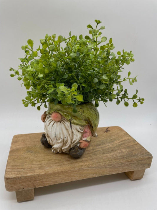 vivid green realistic faux plants in gnome shaped ceramic pot vase