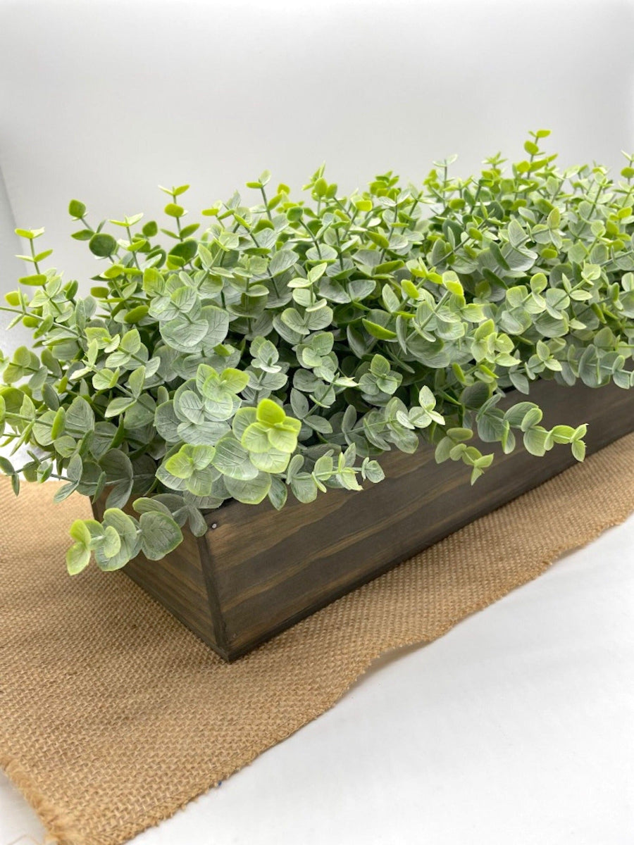 close up for faux Eucalyptus Centerpiece in wooden planter