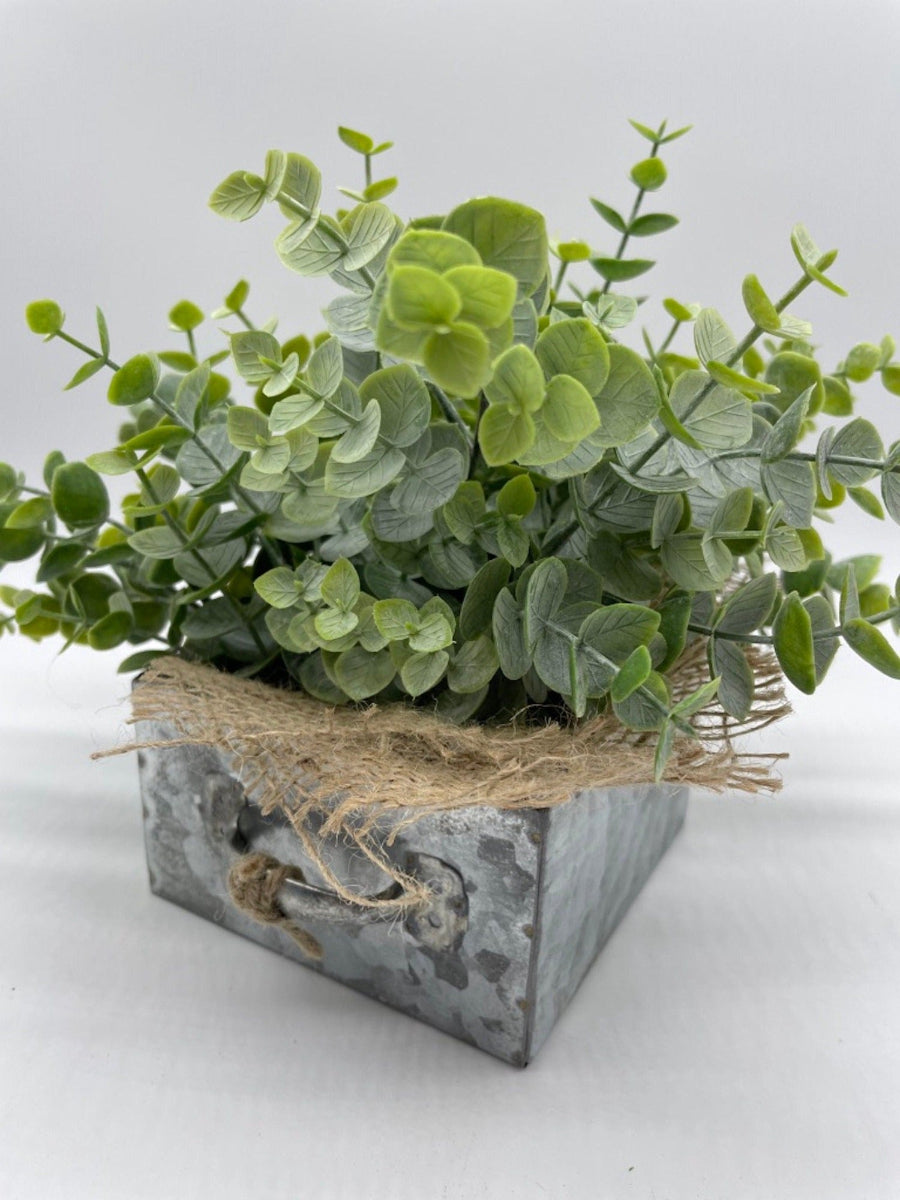 Faux Eucalyptus Arrangement in metal drawer planter decorated with burlap and jute